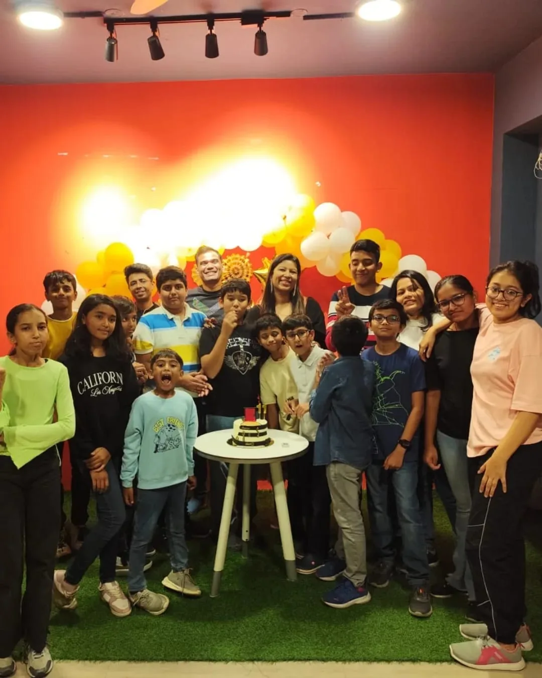 Children gathered for the cake cutting at Bannerghatta Road